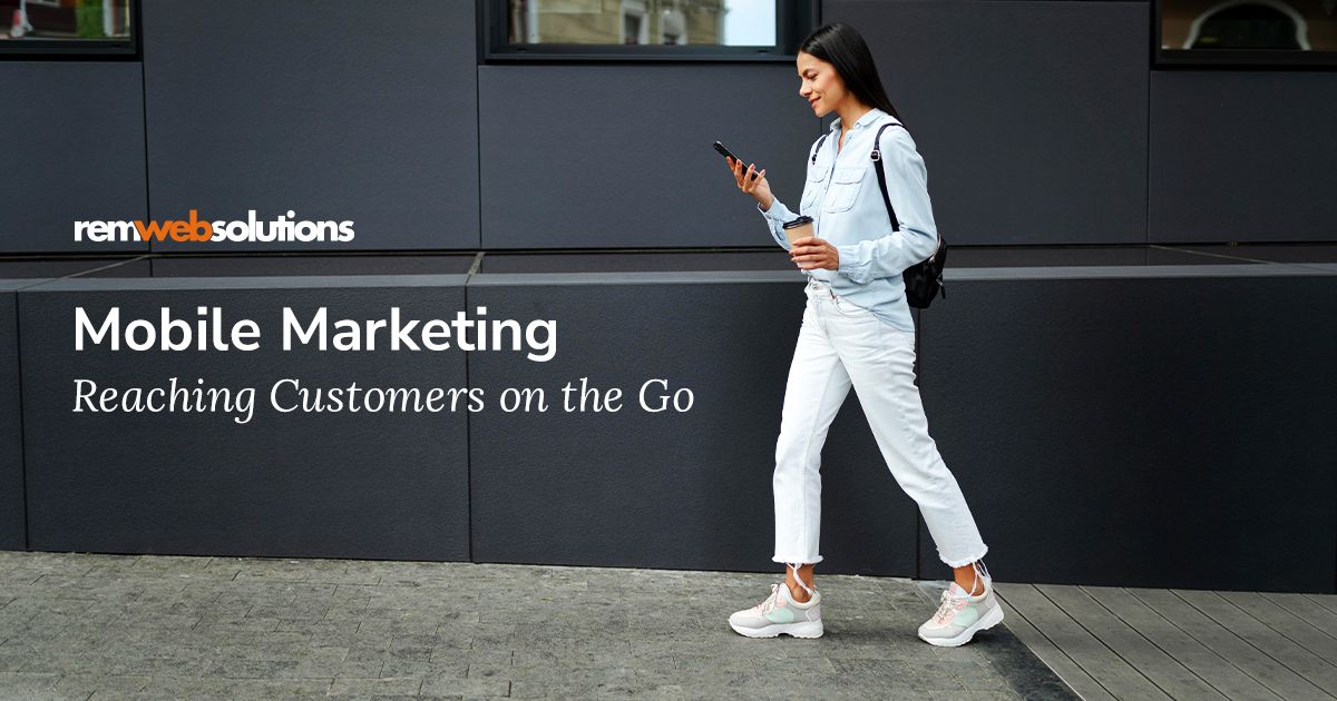 Woman walking on the street while looking at her phone. 